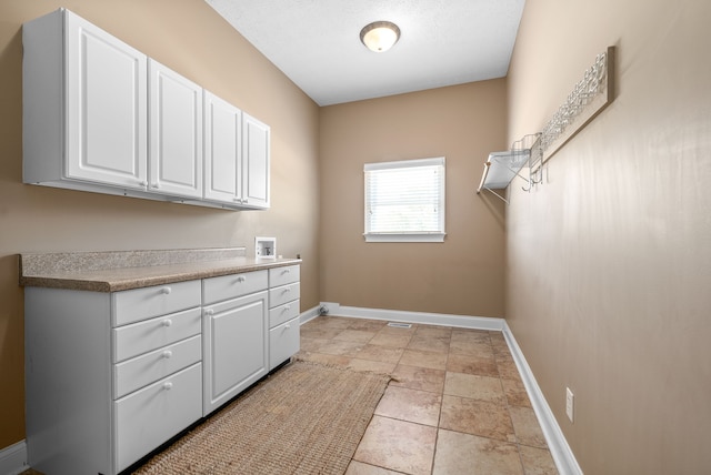 laundry room with washer hookup and cabinets