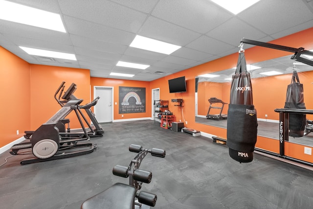 gym featuring a paneled ceiling