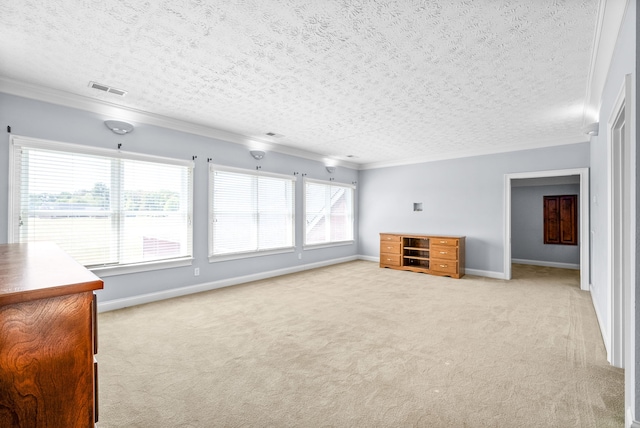 unfurnished living room with light colored carpet, a textured ceiling, and ornamental molding