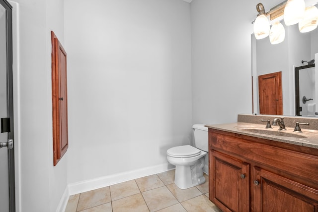 bathroom featuring tile patterned floors, vanity, and toilet