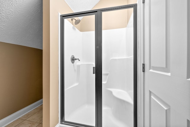 bathroom with tile patterned flooring and an enclosed shower