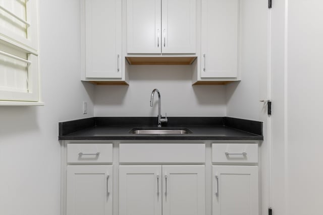 kitchen featuring white cabinets and sink