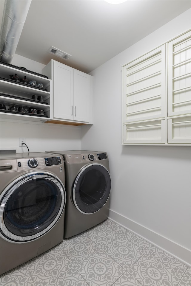 laundry area featuring cabinets and washer and dryer