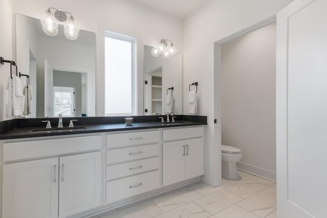 bathroom featuring toilet and vanity