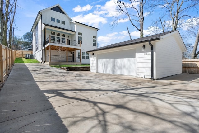 back of house with a garage and a balcony