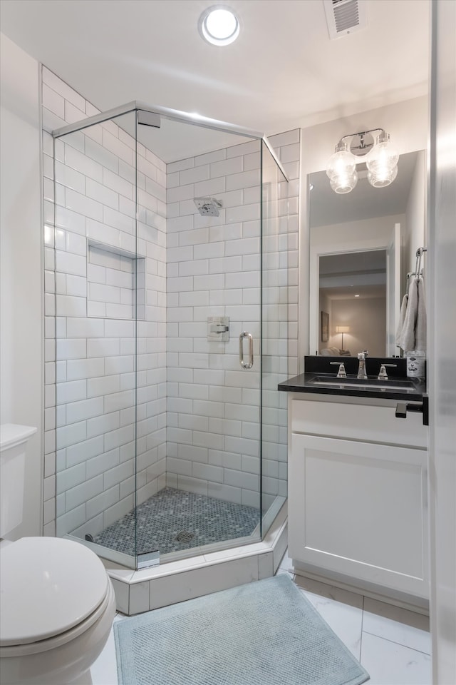 bathroom with walk in shower, vanity, and toilet