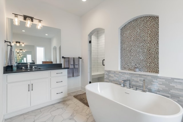 bathroom with vanity and independent shower and bath