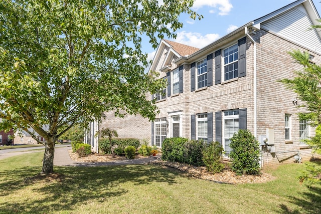 colonial home with a front lawn