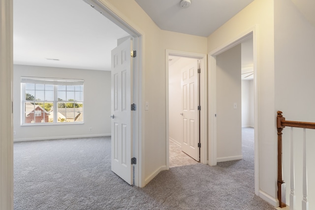 hallway featuring light carpet