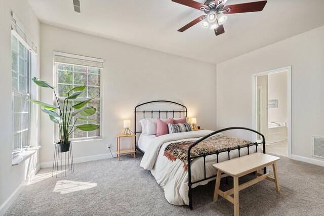 bedroom with carpet floors, ensuite bathroom, and ceiling fan