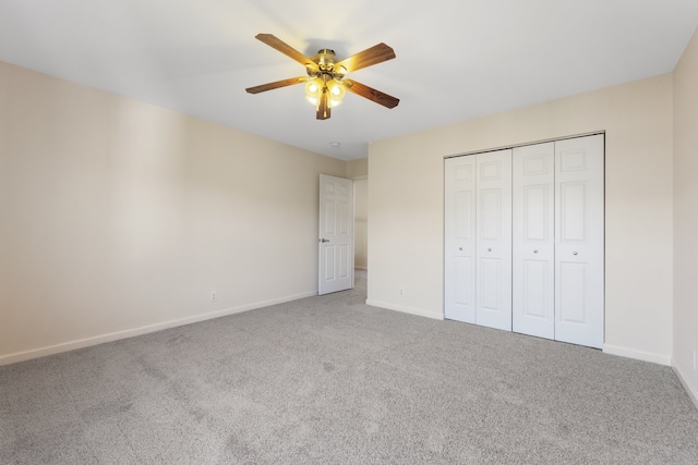 unfurnished bedroom featuring ceiling fan, a closet, and carpet