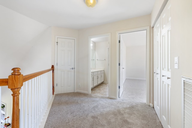 corridor with light colored carpet