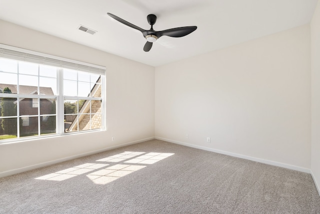 carpeted spare room with ceiling fan