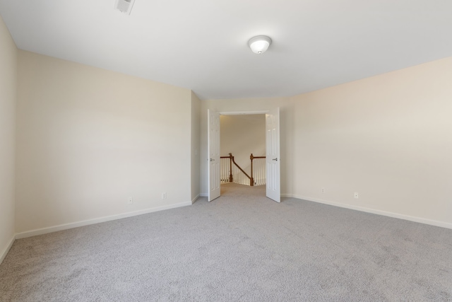 unfurnished room with light carpet