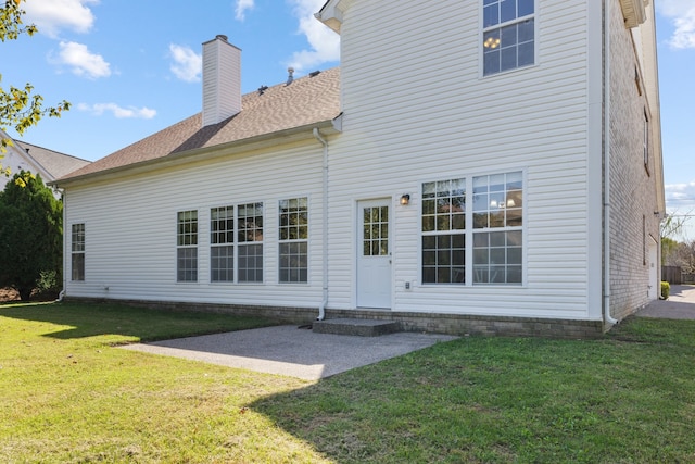 back of house with a yard and a patio area