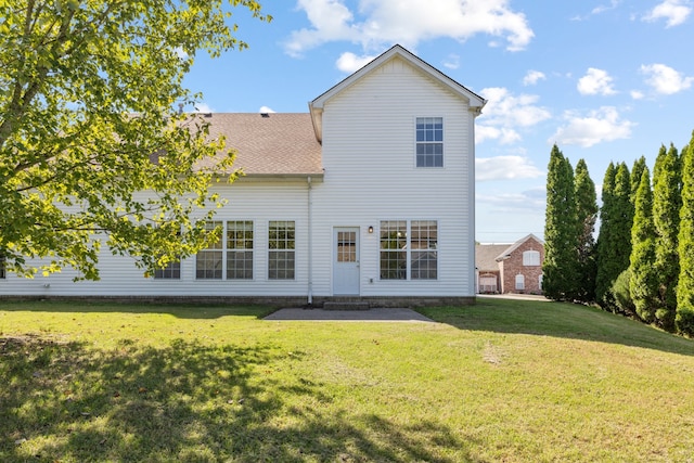 back of property featuring a yard and a patio