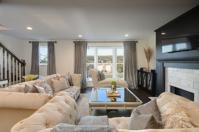 living room with dark hardwood / wood-style floors and a fireplace