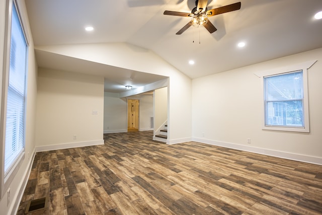 unfurnished room featuring ceiling fan, dark wood-type flooring, a wealth of natural light, and vaulted ceiling