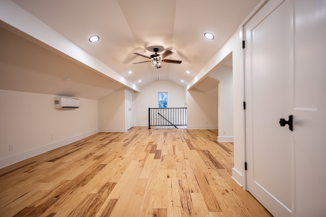 bonus room featuring ceiling fan, light hardwood / wood-style floors, lofted ceiling, and a wall unit AC