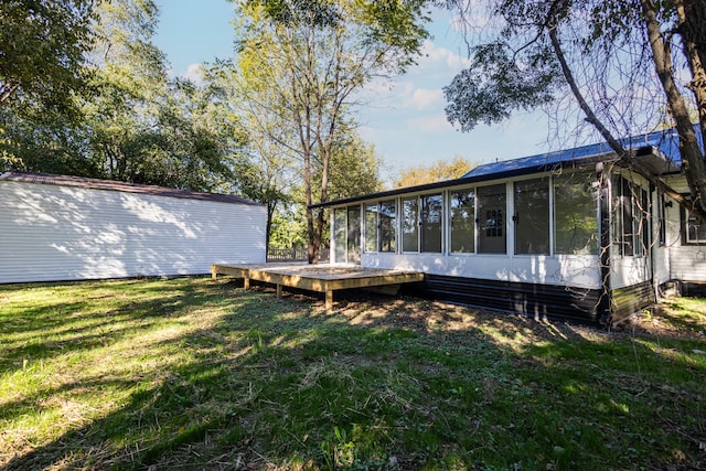 view of yard featuring a deck and a sunroom