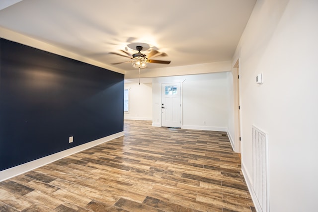 unfurnished room featuring hardwood / wood-style floors and ceiling fan