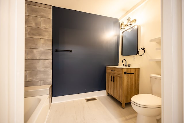 bathroom featuring a bathtub, vanity, and toilet