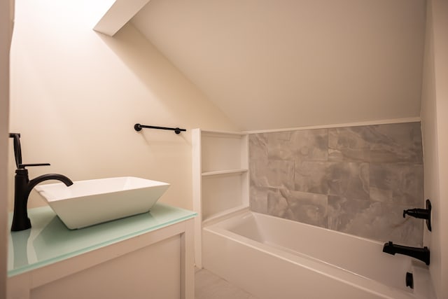 bathroom with vanity and vaulted ceiling