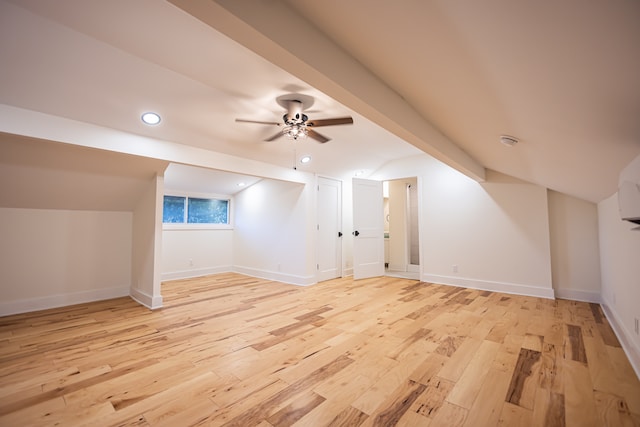 additional living space featuring light hardwood / wood-style floors, vaulted ceiling, and ceiling fan