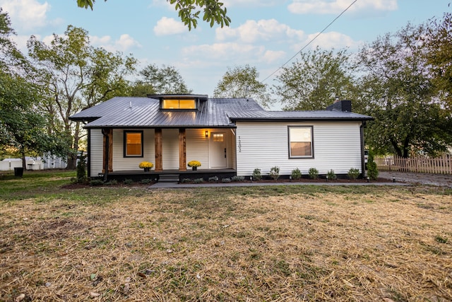 view of front of property with covered porch and a front lawn