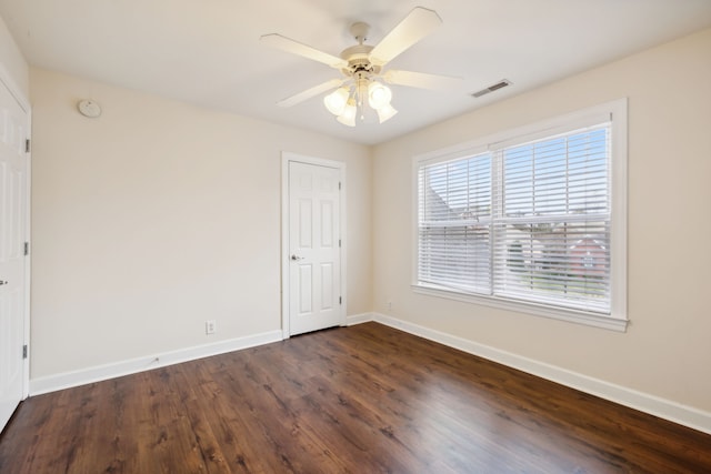 unfurnished room featuring ceiling fan and dark hardwood / wood-style floors