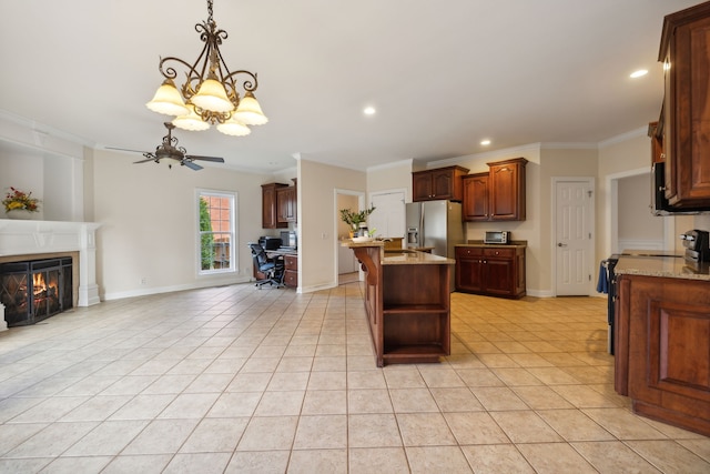 kitchen featuring ceiling fan with notable chandelier, stainless steel appliances, a center island, ornamental molding, and light tile patterned flooring