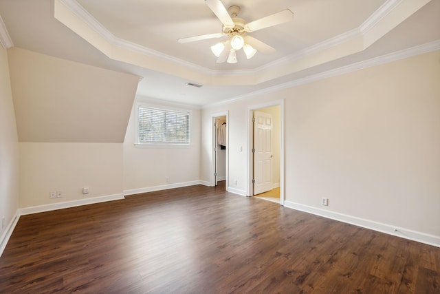 unfurnished bedroom featuring dark hardwood / wood-style flooring, a tray ceiling, ceiling fan, and crown molding