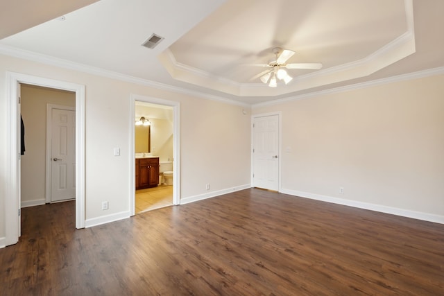 unfurnished bedroom with dark hardwood / wood-style flooring, ceiling fan, and a raised ceiling