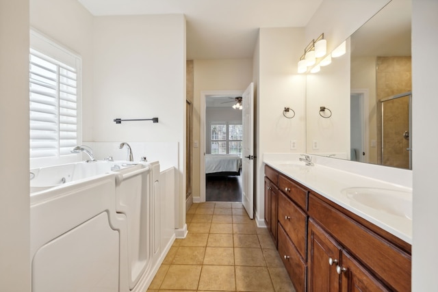 bathroom featuring vanity, ceiling fan, tile patterned flooring, and a bathing tub