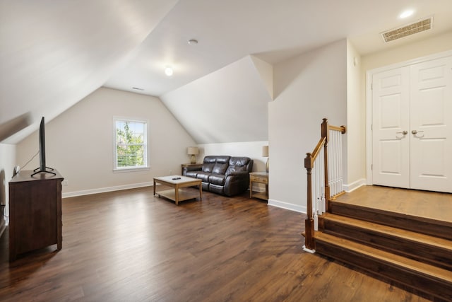 interior space with dark hardwood / wood-style flooring and vaulted ceiling