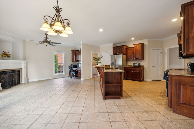 kitchen featuring stainless steel appliances, light stone counters, ceiling fan with notable chandelier, crown molding, and a kitchen island