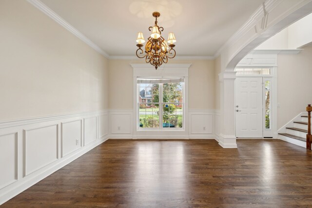 interior space with dark hardwood / wood-style floors, crown molding, and an inviting chandelier