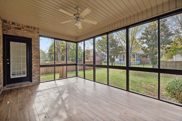 unfurnished sunroom with ceiling fan and wood ceiling