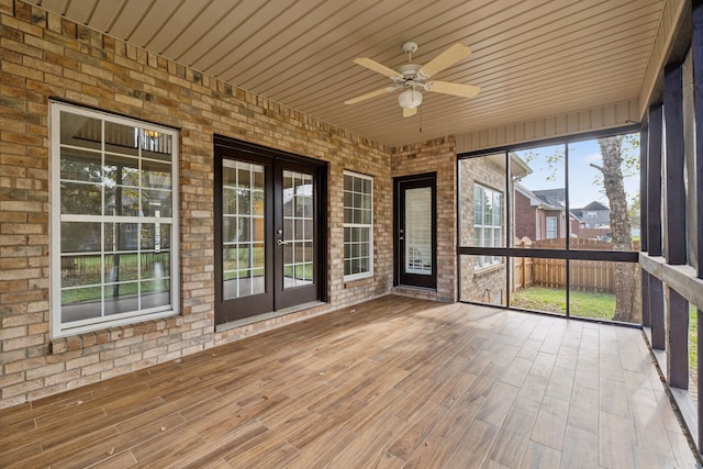 unfurnished sunroom featuring ceiling fan and wood ceiling