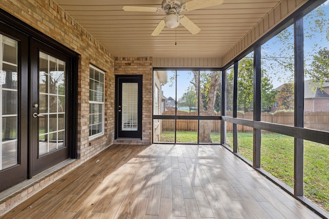 unfurnished sunroom with ceiling fan and wood ceiling