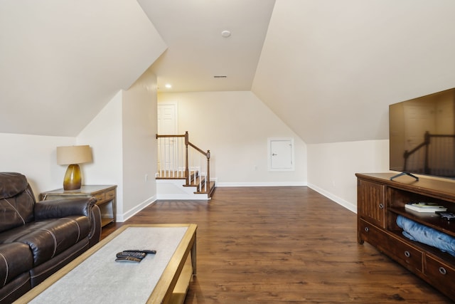 living room featuring dark hardwood / wood-style floors and vaulted ceiling