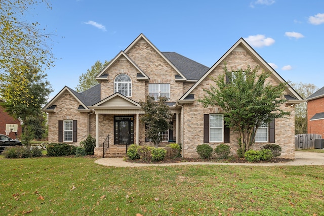 craftsman-style home with central AC unit and a front yard