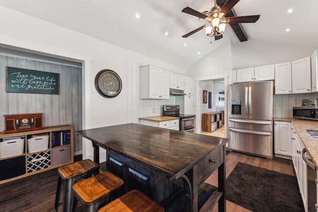 kitchen with a kitchen island, dark hardwood / wood-style flooring, white cabinetry, appliances with stainless steel finishes, and beam ceiling