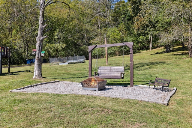 view of home's community featuring a yard and a fire pit