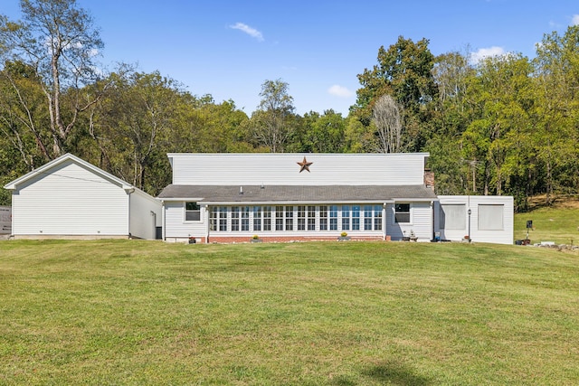 rear view of property with a lawn