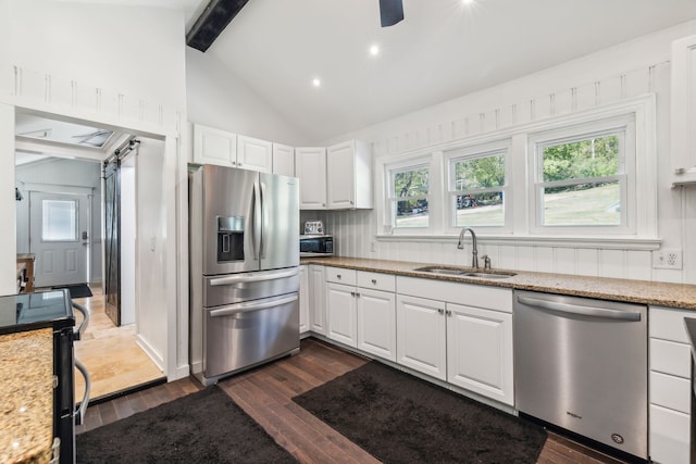 kitchen with white cabinets, sink, stainless steel appliances, dark hardwood / wood-style floors, and light stone countertops