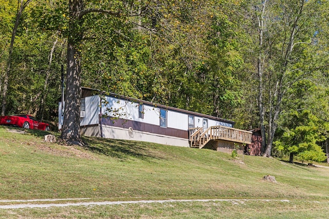 view of front of home with a front yard and a wooden deck