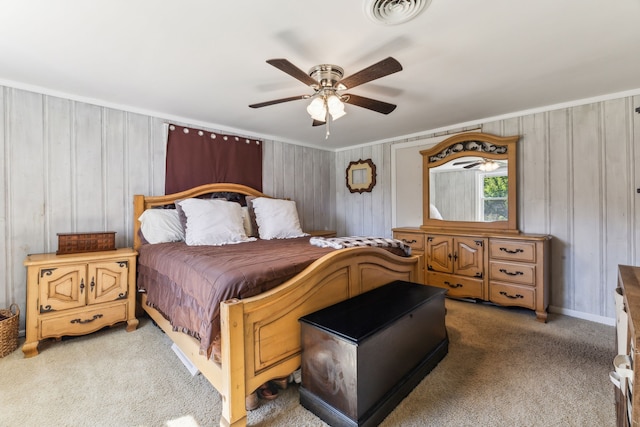 carpeted bedroom featuring ceiling fan and ornamental molding