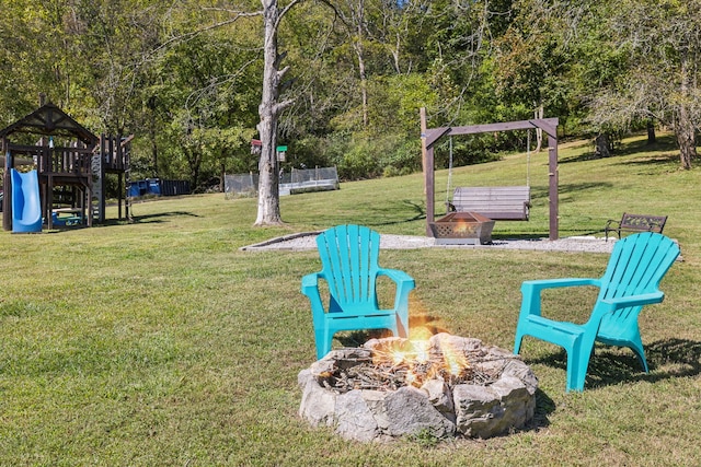 view of yard featuring a playground and a fire pit