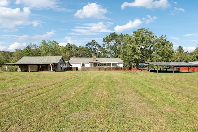 view of yard featuring a rural view and an outdoor structure